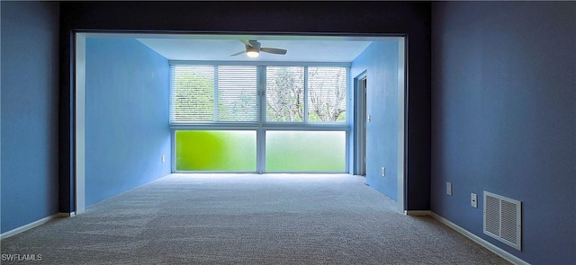 spare room featuring ceiling fan and carpet flooring