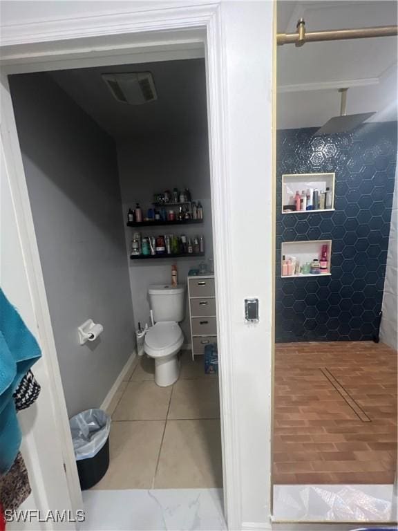 bathroom with tile patterned flooring and toilet