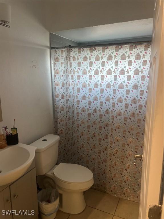 bathroom featuring tile patterned floors, vanity, and toilet