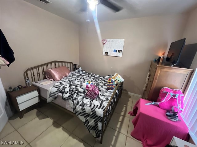 tiled bedroom with ceiling fan