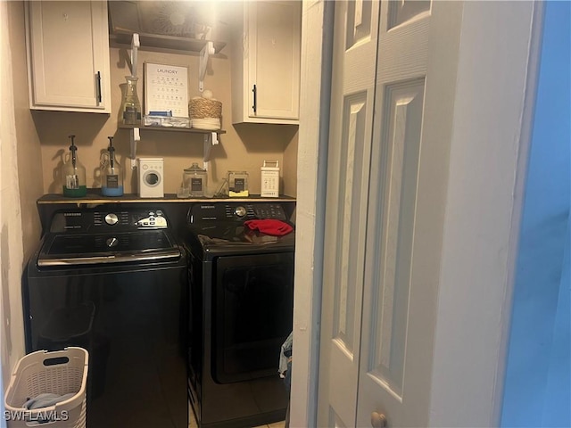 washroom featuring cabinets and separate washer and dryer