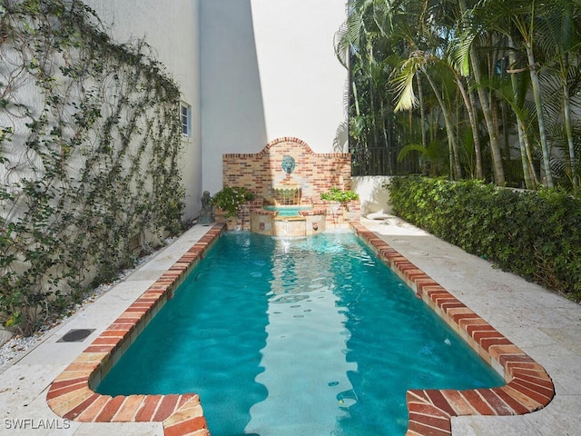 view of pool with an in ground hot tub and pool water feature