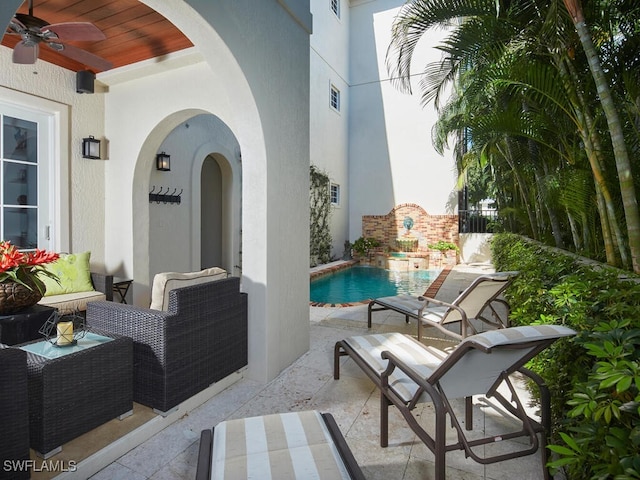 view of patio / terrace featuring a fenced in pool and ceiling fan