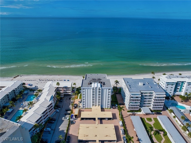 birds eye view of property with a water view and a view of the beach