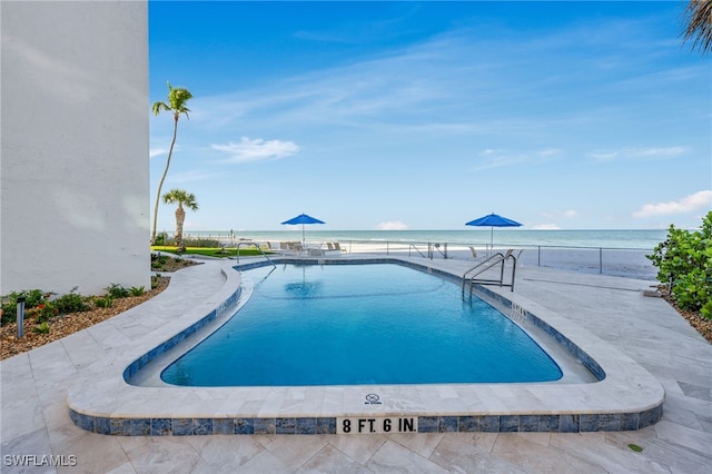 view of pool featuring a water view