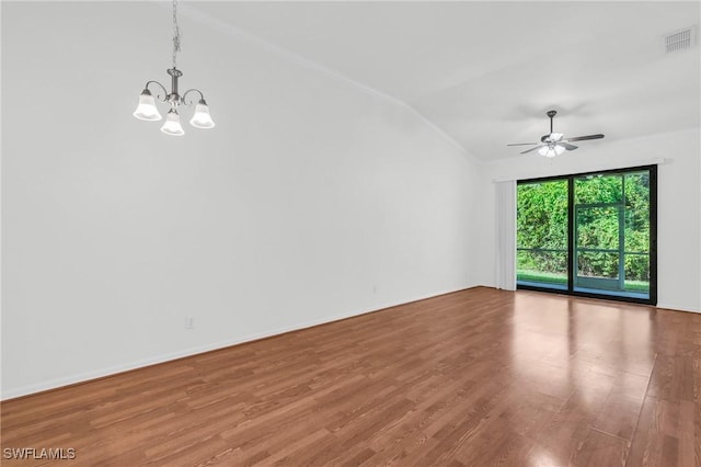 spare room featuring wood-type flooring, ceiling fan with notable chandelier, and lofted ceiling