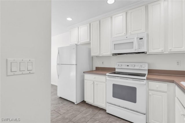 kitchen with white cabinetry and white appliances