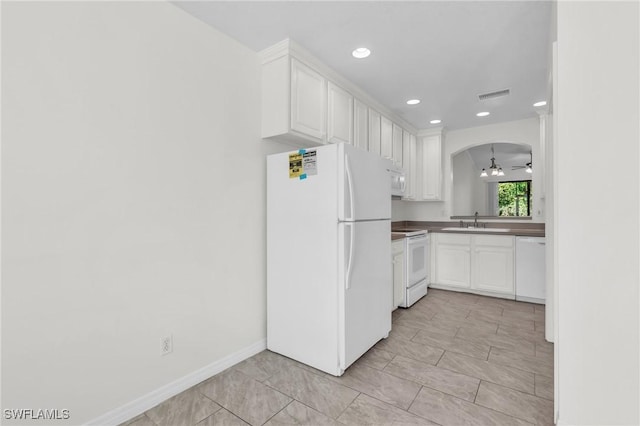 kitchen featuring white appliances, white cabinetry, ceiling fan, and sink