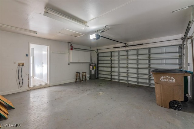 garage with electric water heater and a garage door opener