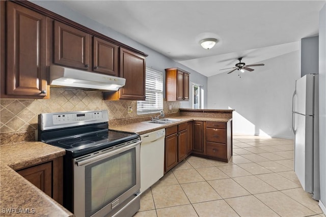 kitchen with kitchen peninsula, stainless steel appliances, ceiling fan, sink, and light tile patterned floors