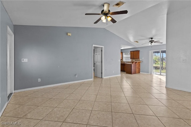 unfurnished living room featuring ceiling fan, light tile patterned floors, and vaulted ceiling