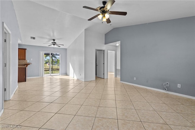 tiled spare room with ceiling fan and vaulted ceiling