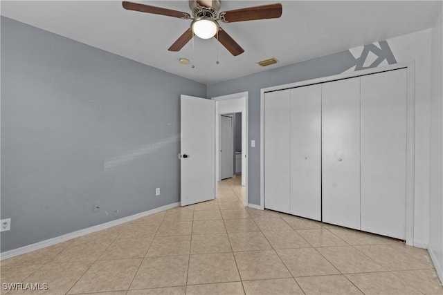 unfurnished bedroom with ceiling fan, a closet, and light tile patterned flooring