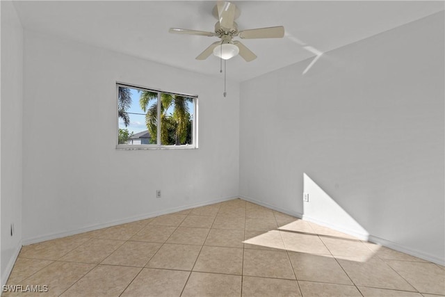 tiled spare room featuring ceiling fan