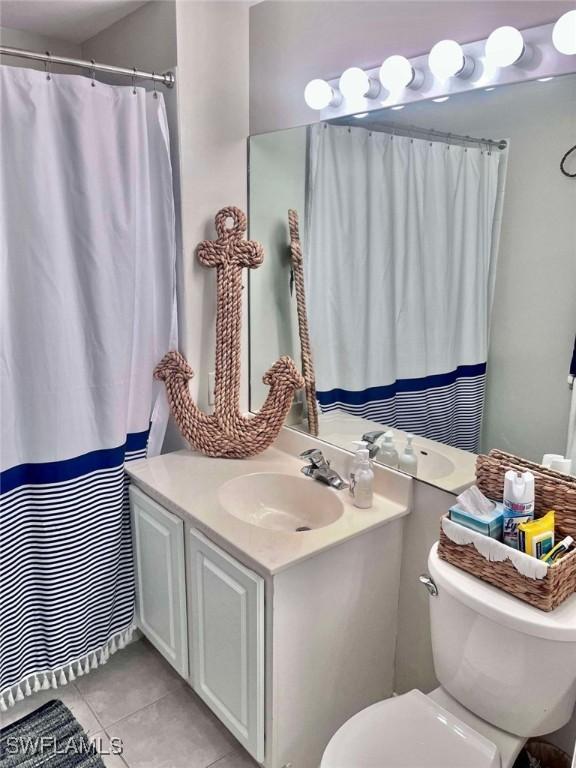 bathroom featuring vanity, toilet, and tile patterned flooring