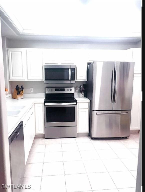 kitchen with white cabinetry, stainless steel appliances, sink, and light tile patterned floors