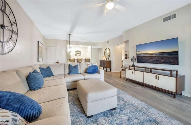 living room with hardwood / wood-style flooring and ceiling fan