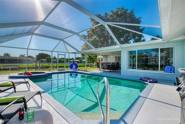 view of pool with an in ground hot tub, a patio, and glass enclosure