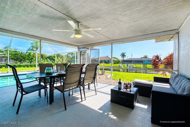 sunroom / solarium featuring ceiling fan