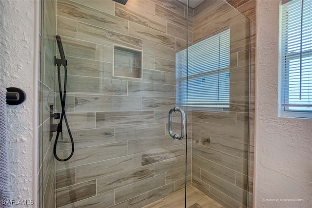 bathroom with a shower with shower door