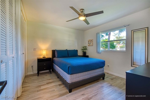 bedroom with light hardwood / wood-style floors and ceiling fan