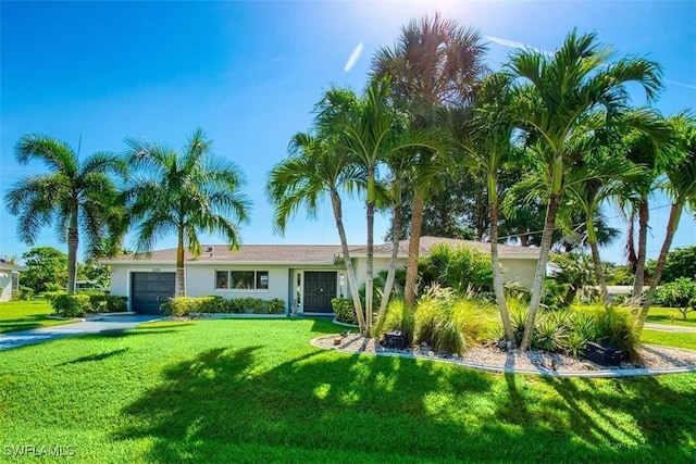 view of front of property with a garage and a front lawn