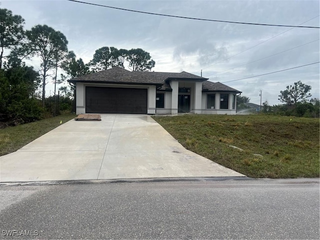 view of front of home with a garage and a front lawn