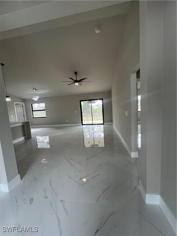 empty room with plenty of natural light and ceiling fan