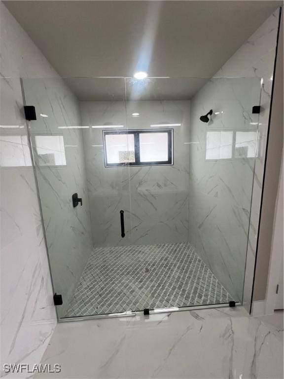 bathroom featuring a shower with shower door