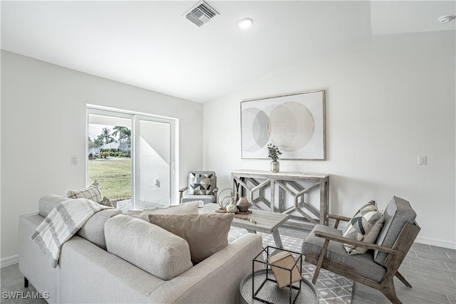 living room featuring hardwood / wood-style flooring and vaulted ceiling