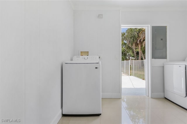 washroom with electric panel, a healthy amount of sunlight, light tile patterned floors, and washer / clothes dryer