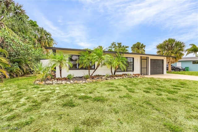 single story home with a garage and a front lawn