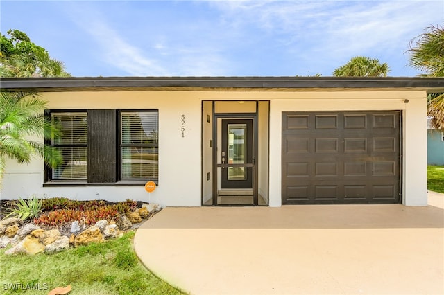 doorway to property with a garage