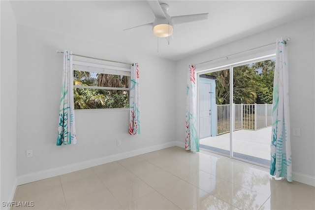 unfurnished room with light tile patterned floors and ceiling fan