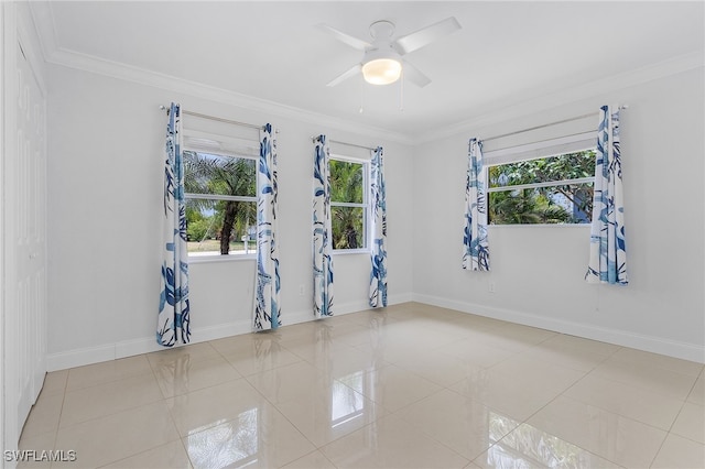 empty room with crown molding, light tile patterned floors, and ceiling fan