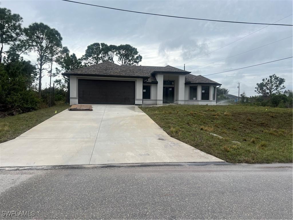 view of front of property with a garage and a front yard