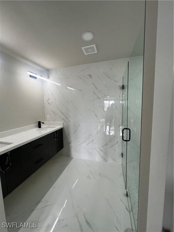 bathroom with vanity and an enclosed shower