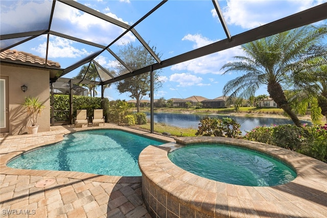 view of pool with an in ground hot tub, a water view, glass enclosure, and a patio