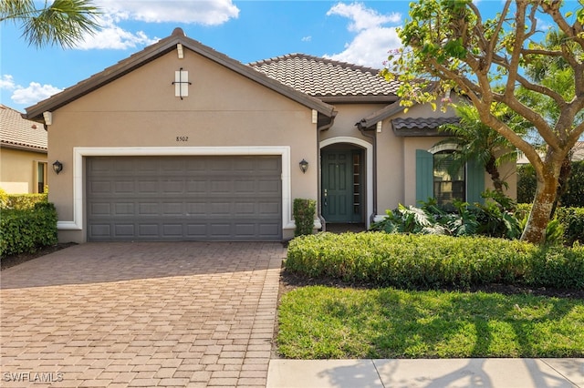 mediterranean / spanish house with a garage