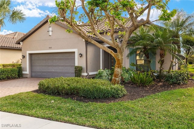 view of front of property featuring a garage and a front yard