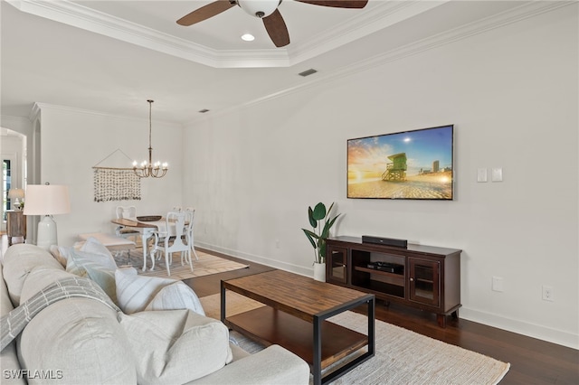 living room featuring crown molding, a tray ceiling, dark hardwood / wood-style flooring, and ceiling fan with notable chandelier