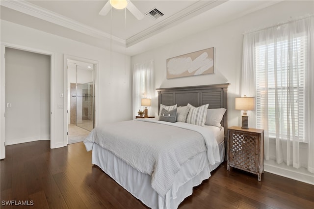 bedroom featuring a raised ceiling, ornamental molding, dark wood-type flooring, and ceiling fan