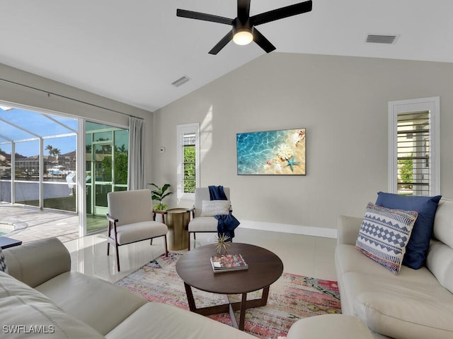 tiled living room featuring ceiling fan and vaulted ceiling