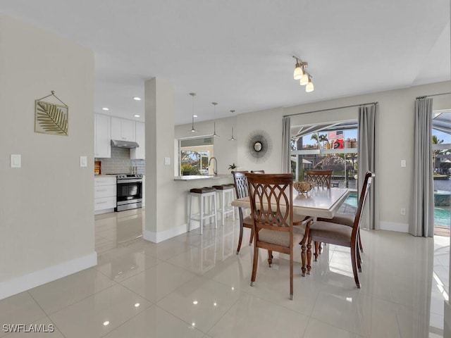 dining space featuring light tile patterned flooring