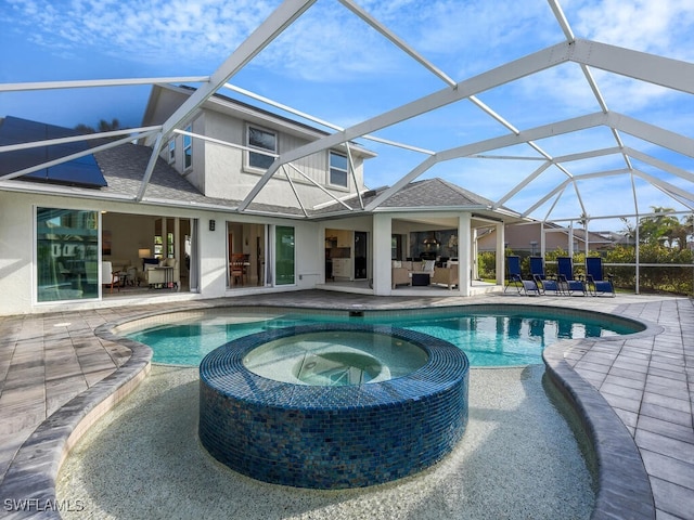 view of swimming pool with an in ground hot tub, a lanai, and a patio