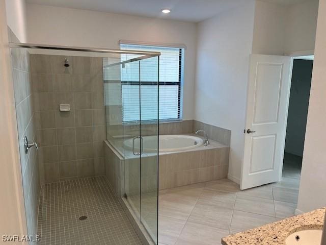 bathroom featuring tile patterned floors, vanity, and plus walk in shower