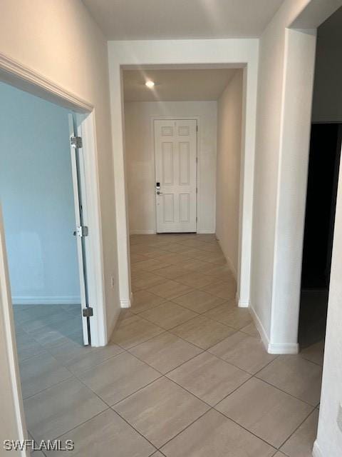 hallway featuring light tile patterned floors