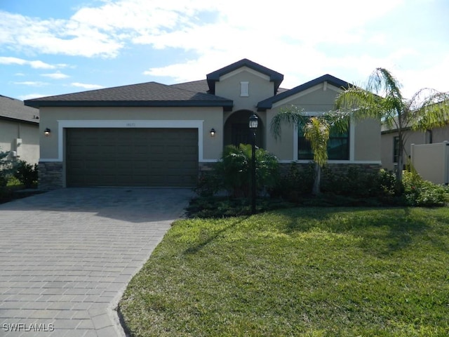 view of front of home with a front lawn and a garage