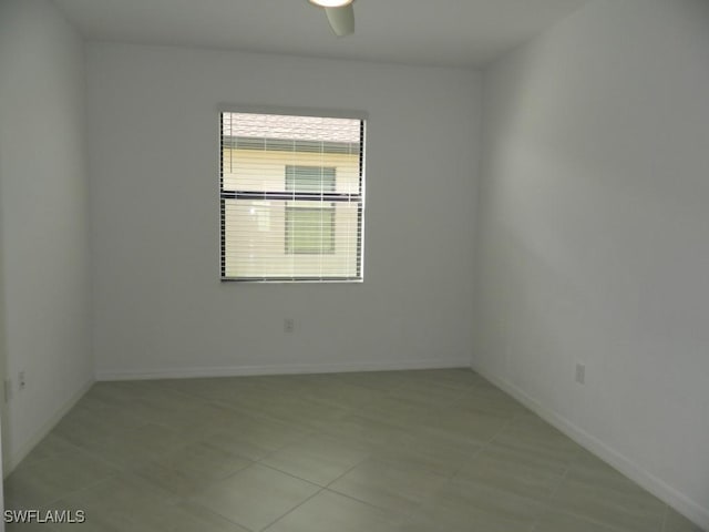 tiled empty room with ceiling fan