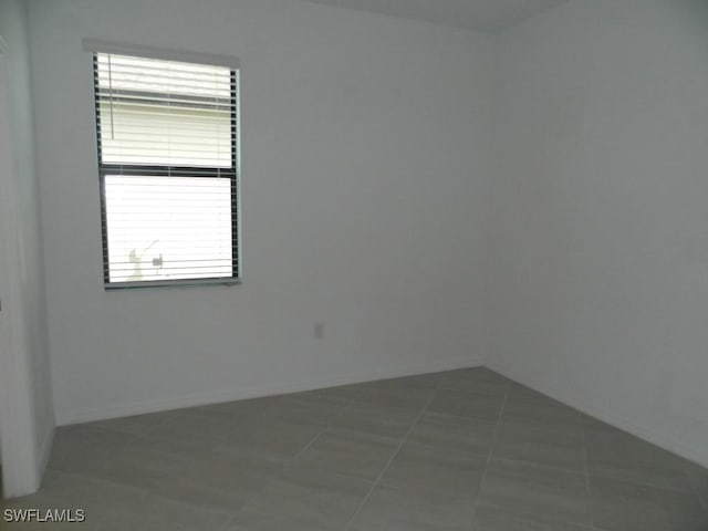 spare room featuring tile patterned flooring